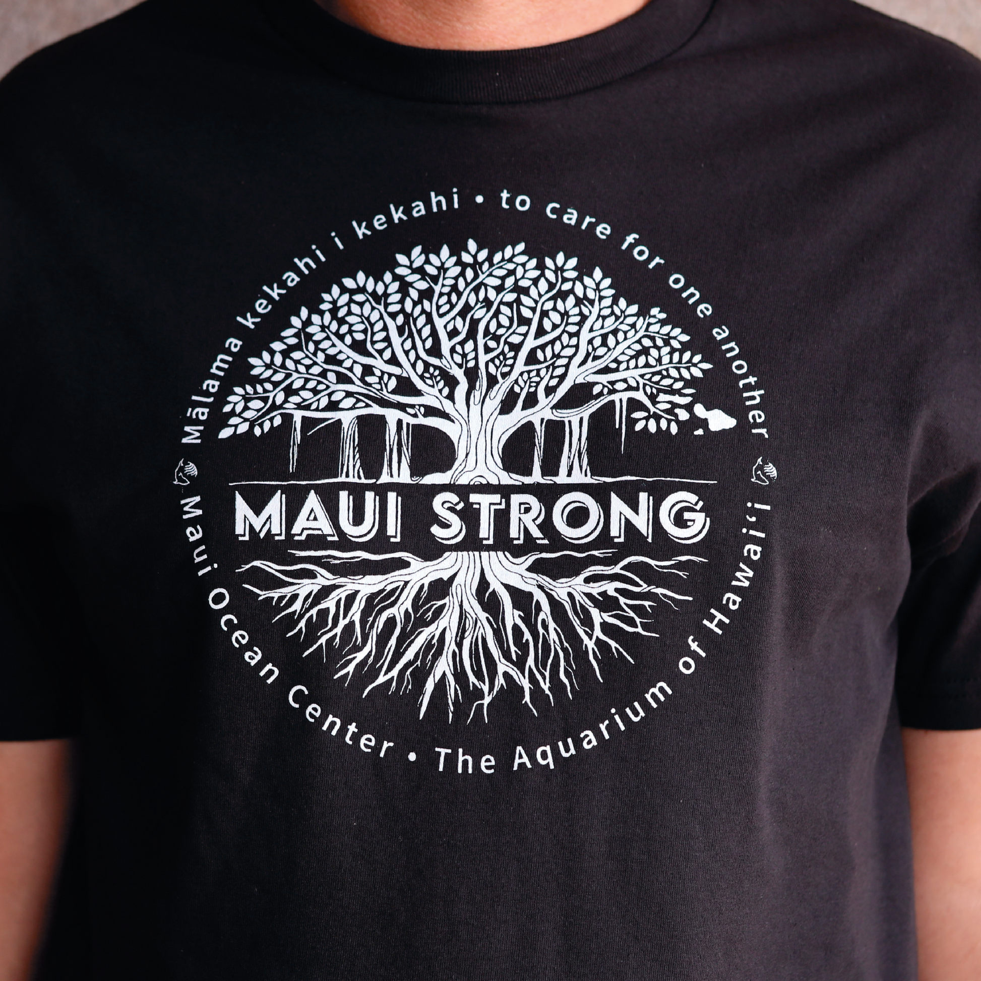 Maui Strong T-shirt, white graphic on black shirt. Locally designed and printed. Sales donated to Hawaiʻi Community Foundationʻs Maui Strong Fund, which support people impacted & displaced by the Maui wildfires.